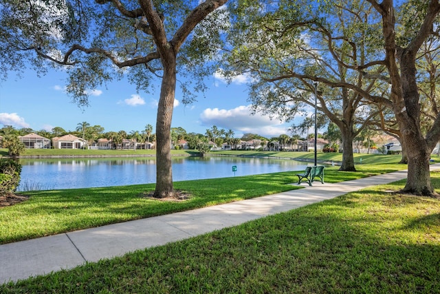 view of home's community featuring a yard and a water view