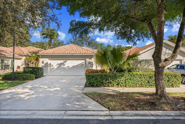 mediterranean / spanish home featuring a garage