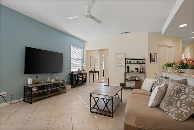 tiled living room with ceiling fan