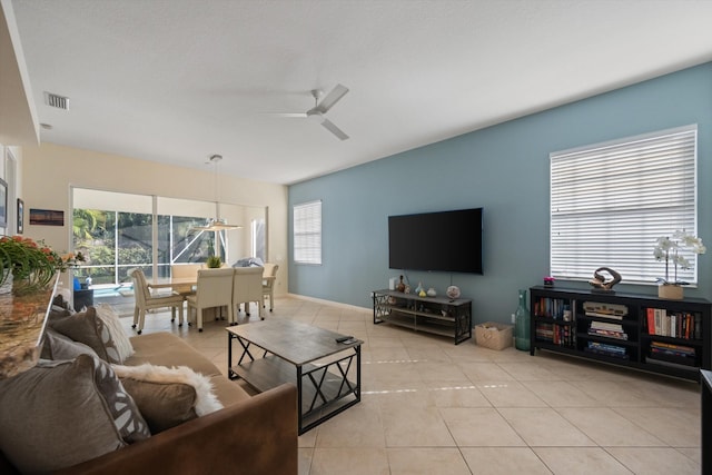 tiled living room featuring ceiling fan