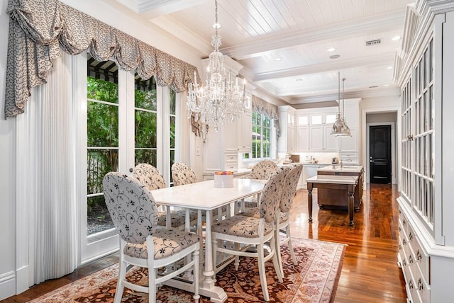 dining area with beamed ceiling, dark hardwood / wood-style flooring, an inviting chandelier, and ornamental molding