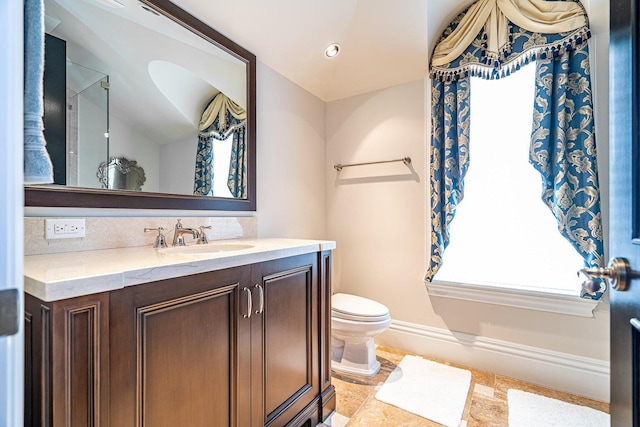 bathroom with decorative backsplash, vanity, and toilet