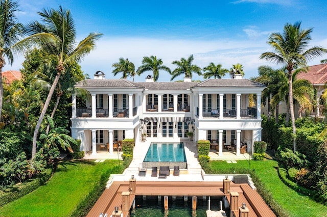 back of house with a patio, a balcony, and a lawn