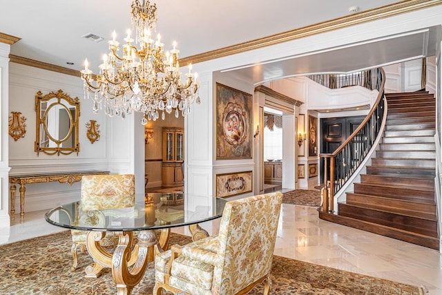 dining area with decorative columns, ornamental molding, and a notable chandelier