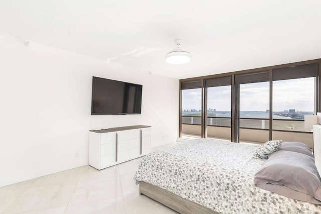 bedroom featuring access to outside, ceiling fan, and light tile patterned floors