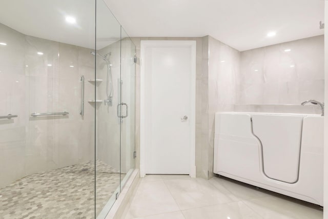 bathroom with tile patterned flooring and a shower with shower door