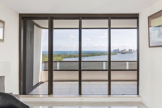 entryway with a water view and light tile patterned floors