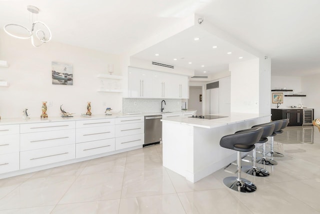 kitchen featuring tasteful backsplash, stainless steel dishwasher, black electric cooktop, decorative light fixtures, and white cabinets