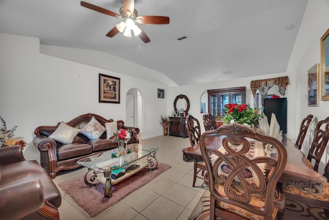 tiled living room featuring ceiling fan and vaulted ceiling