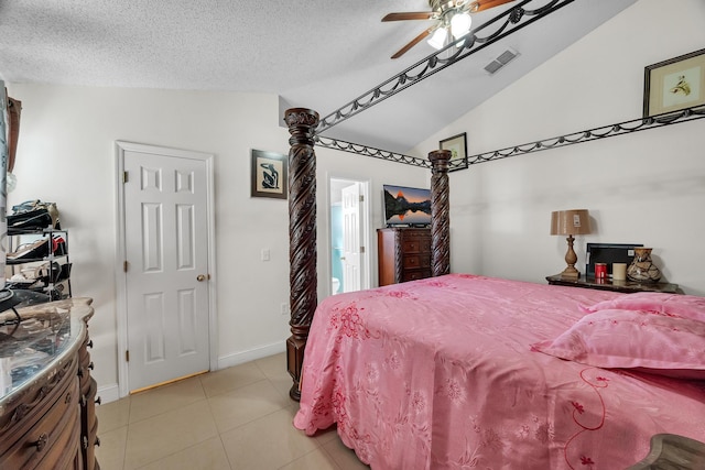 tiled bedroom featuring a textured ceiling, vaulted ceiling, and ceiling fan