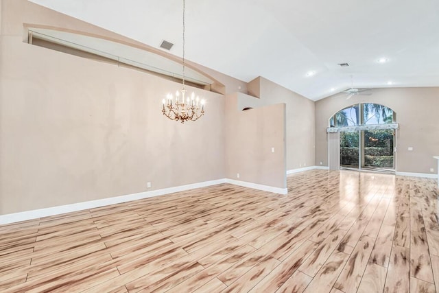 unfurnished living room with ceiling fan with notable chandelier, light hardwood / wood-style floors, and lofted ceiling