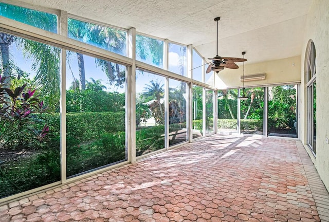 unfurnished sunroom featuring ceiling fan