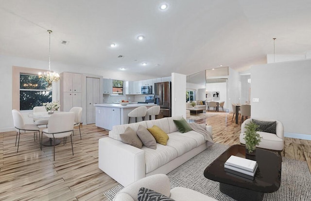 living room featuring light hardwood / wood-style flooring and a chandelier