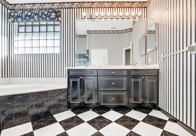 bathroom featuring vanity and a relaxing tiled tub