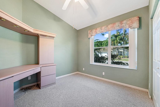 unfurnished office featuring ceiling fan, light colored carpet, and lofted ceiling