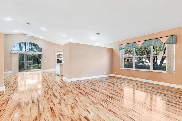 unfurnished living room with ceiling fan, light hardwood / wood-style floors, and lofted ceiling