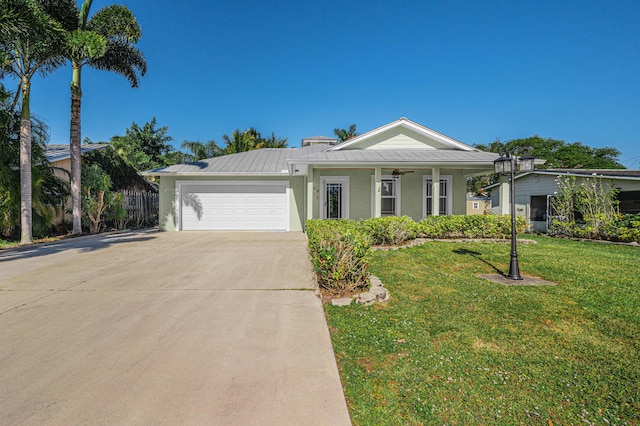 ranch-style house with ceiling fan, a garage, and a front lawn