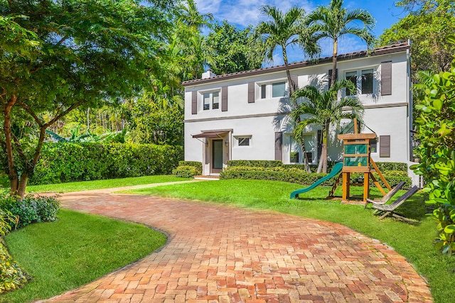 view of front of property featuring a front yard and a playground