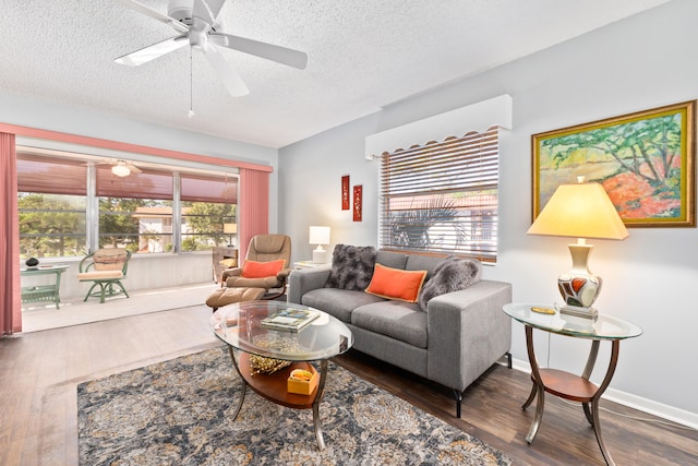 living room featuring a textured ceiling, dark hardwood / wood-style flooring, and ceiling fan