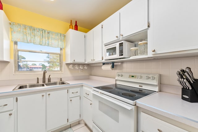 kitchen featuring white cabinets, backsplash, white appliances, and sink