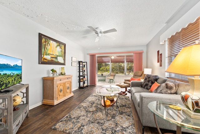 living room with a textured ceiling, ceiling fan, and dark hardwood / wood-style floors