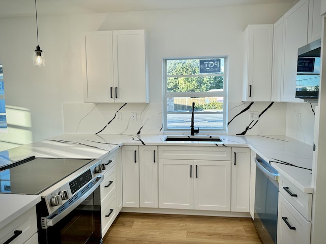 kitchen featuring white cabinetry, stainless steel appliances, and a sink