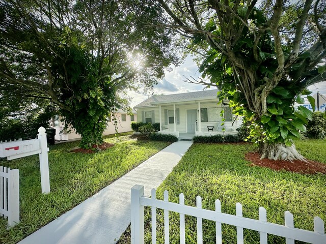 obstructed view of property with a front lawn