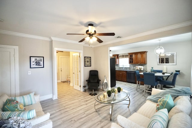 living room with ornamental molding, baseboards, visible vents, and light wood finished floors