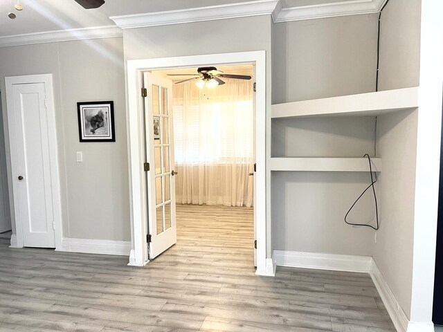 hallway with ornamental molding, wood finished floors, and baseboards