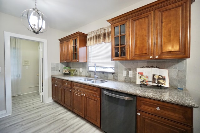 kitchen with tasteful backsplash, dishwashing machine, light wood-style flooring, glass insert cabinets, and a sink