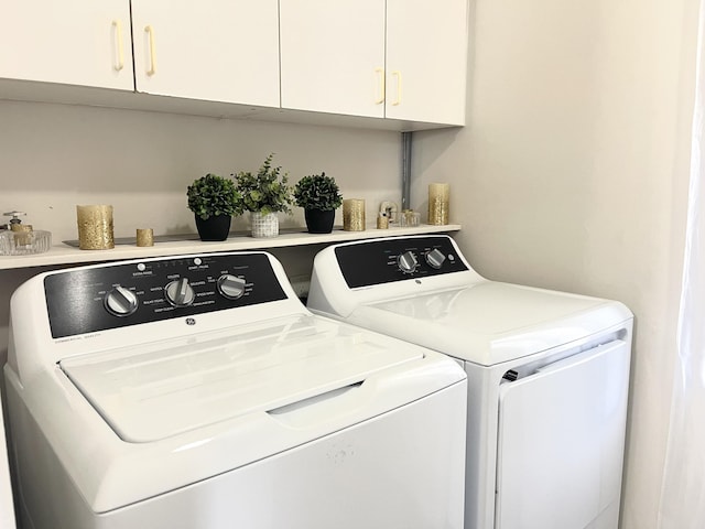 clothes washing area with cabinet space and washing machine and clothes dryer