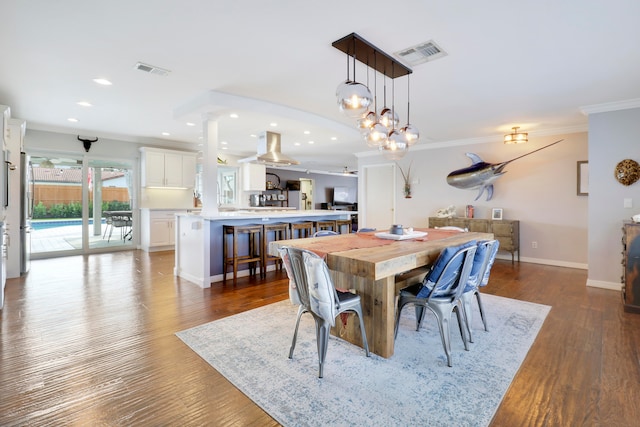 dining room featuring ceiling fan, wood-type flooring, and crown molding