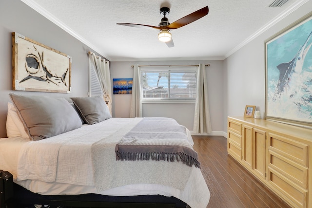 bedroom featuring ceiling fan, crown molding, wood-type flooring, and a textured ceiling