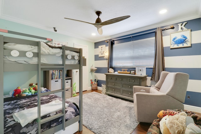 bedroom featuring ceiling fan, hardwood / wood-style floors, and crown molding