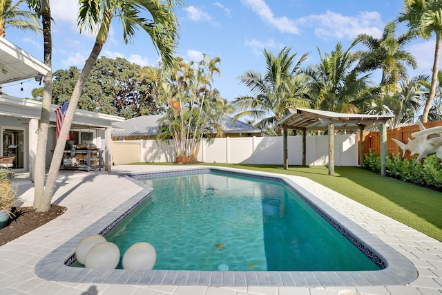 view of swimming pool featuring a patio and a lawn