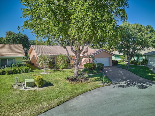 view of front of house with a garage and a front lawn