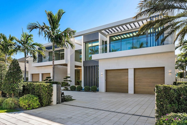 modern home featuring a garage and a balcony