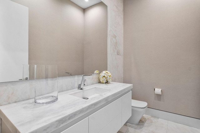 bathroom featuring tile patterned floors, vanity, and toilet