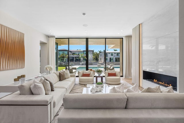 living room with floor to ceiling windows and a premium fireplace