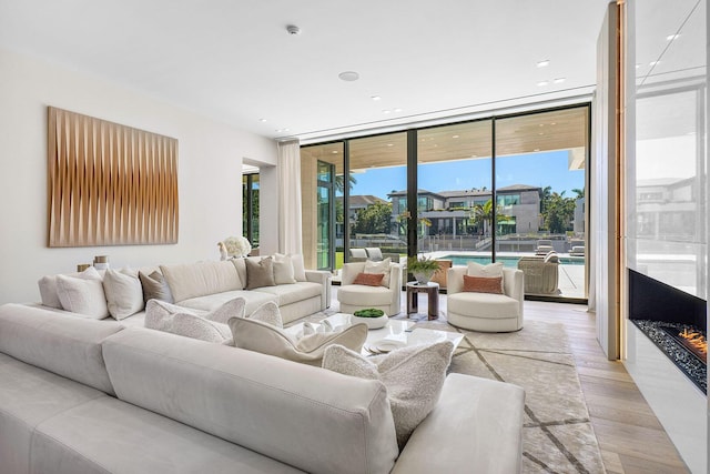 living room featuring light hardwood / wood-style floors and floor to ceiling windows