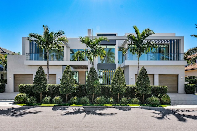 224 W Key Palm Rd, Boca Raton, FL 33432 - contemporary home with stucco siding, an attached garage, a balcony, and concrete driveway
