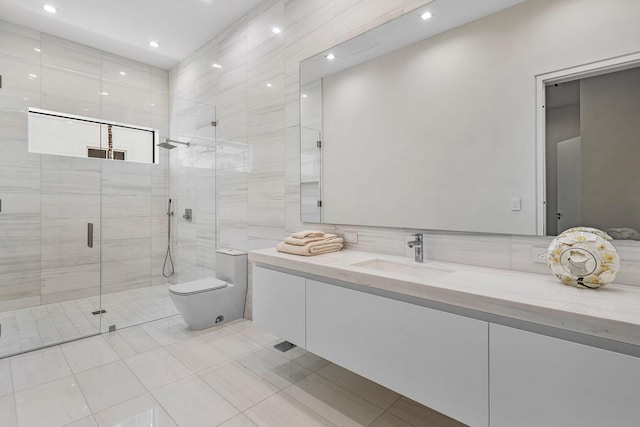 bathroom with tile patterned floors, vanity, toilet, and a shower with door