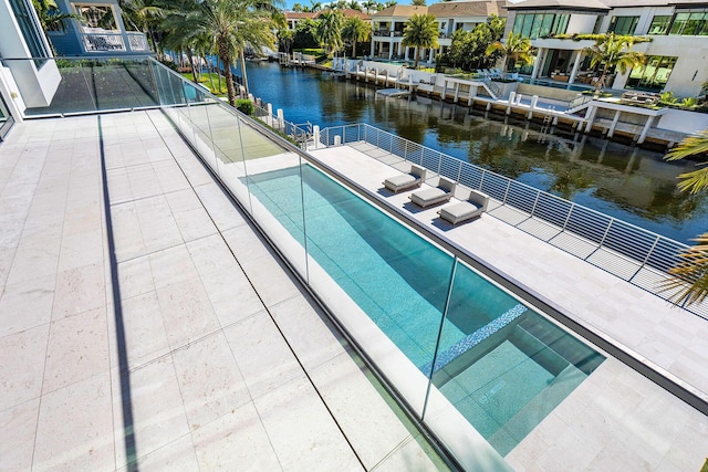 view of swimming pool featuring a water view