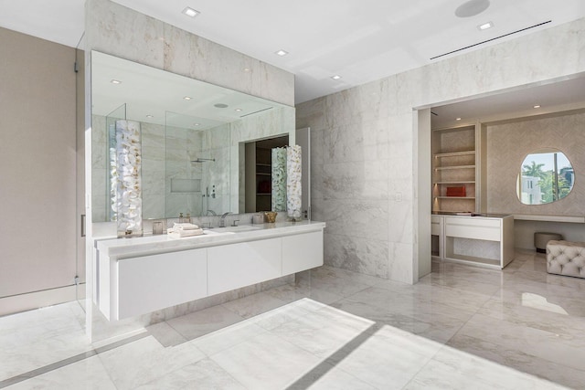 bathroom with tile walls, vanity, and an enclosed shower