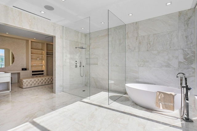 bathroom featuring plus walk in shower, vanity, built in features, and tile walls