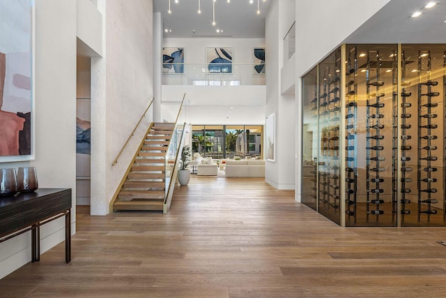 foyer entrance with hardwood / wood-style floors and a high ceiling