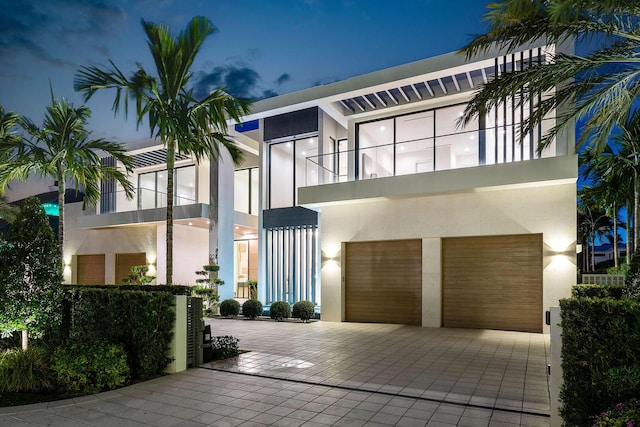 view of front of house featuring a garage and a balcony