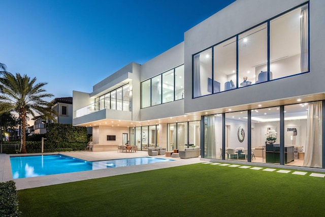 224 W Key Palm Rd, Boca Raton, FL 33432 - rear view of house featuring a balcony, stucco siding, an outdoor pool, and a yard