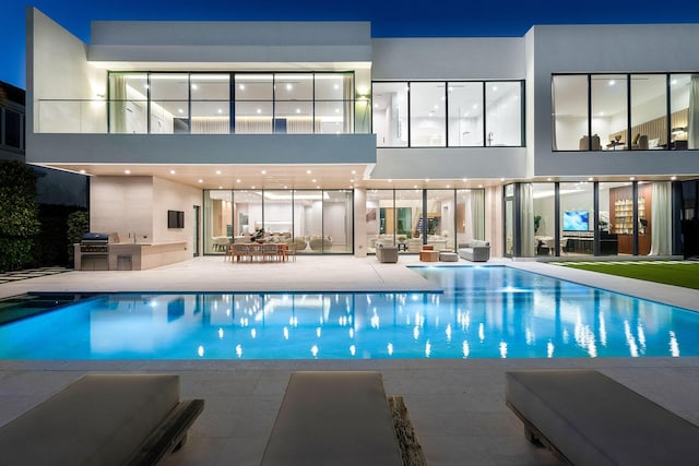 view of swimming pool featuring a patio, area for grilling, and grilling area