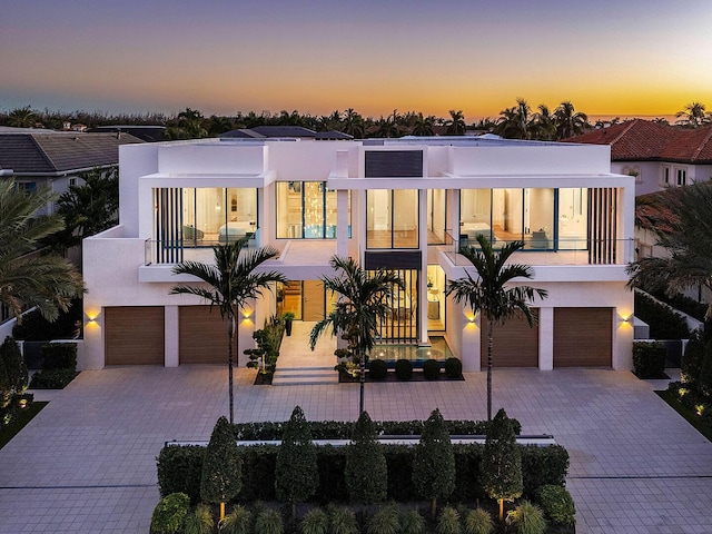 modern home featuring a balcony and a garage